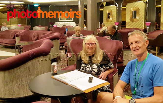 Lisette Williams with son Carl writing her Photomemoirs 2018 onboard cruise ship Symphony of the Seas